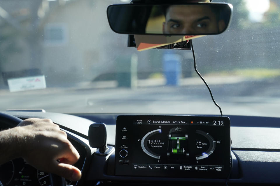 Power Flow information is displayed on the screen of a 2024 Honda CR-V Hybrid as Shalinder Singh drives while being interviewed in Sunnyvale, Calif., Monday, Dec. 11, 2023. Like many hybrid buyers, Singh, an Uber driver, said that for him, the gas savings helped tip the price equation in favor of a Honda CR-V hybrid over the corresponding gasoline model. (AP Photo/Jeff Chiu)