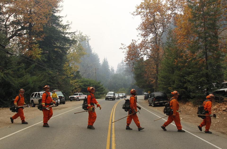 A firefighting crew crosses Highway 1 while deploying to contain a wild fire in Big Sur, California