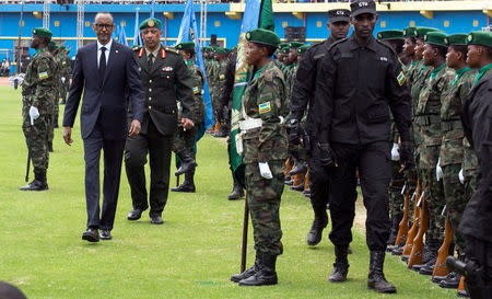 Rwanda's President-elect Paul Kagame (C) inspects the guard of honour before his swearing-in ceremony at Amahoro stadium in Kigali, Rwanda, August 18, 2017. REUTERS/Jean Bizimana