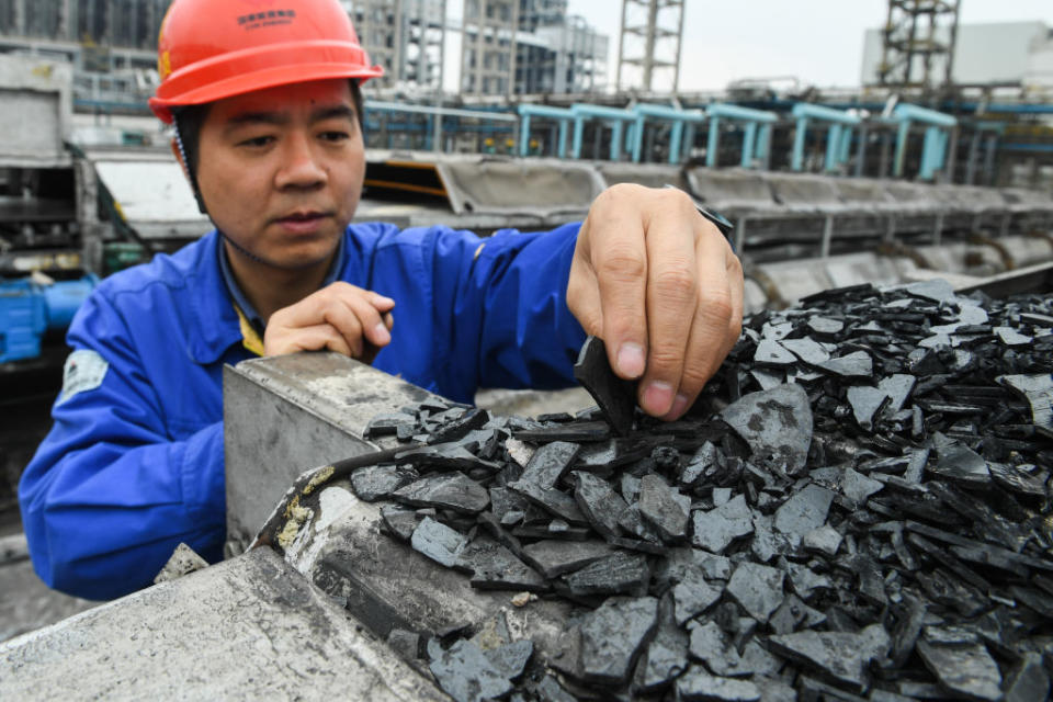 A worker checks byproduct pitch in the coal liquefaction factory belonging to CHN Energy in Ordos, north China's Inner Mongolia Autonomous Region, on April 10, 2019.<span class="copyright">Xinhua/Liu Lei via Getty Images</span>
