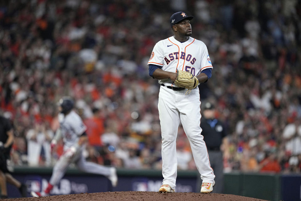 Houston Astros relief pitcher Hector Neris stands on the mound as Minnesota Twins designated hitter Royce Lewis rounds the bases on a solo home run during the seventh inning in Game 1 of an American League Division Series baseball game, Saturday, Oct. 7, 2023, in Houston. (AP Photo/Kevin M. Cox)