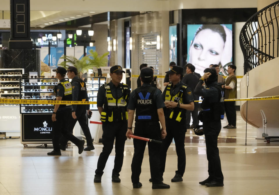 Police officers cordon off the scene near a subway station in Seongnam, South Korea, Thursday, Aug. 3, 2023. A dozen of people were injured in South Korea on Thursday when a man rammed a car onto a sidewalk and then stepped out of the vehicle and began stabbing people near a subway station in the city of Seongnam. (AP Photo/Ahn Young-joon)