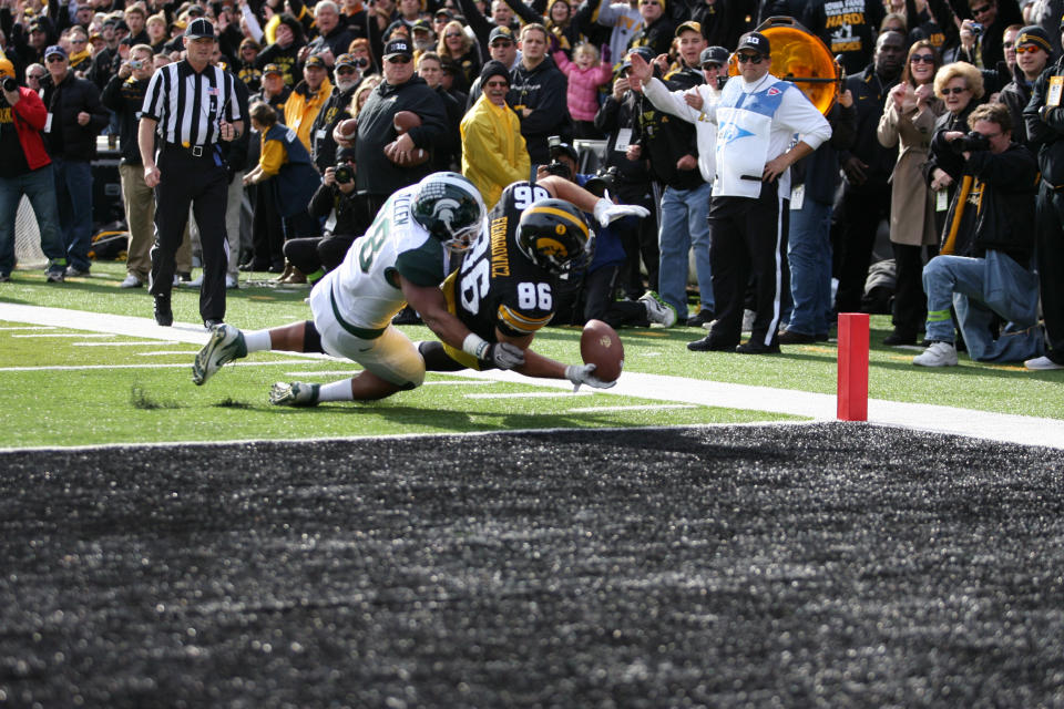 IOWA CITY, IA - NOVEMBER 12: C. J. Fiedororowics #86 of the Iowa Hawkeyes is tackled by Denicos Allen #28 of the Michigan State Spartans at Kinnick Stadium November 12, 2011 in Iowa City, Iowa. (Photo by Reese Strickland/Getty Images)