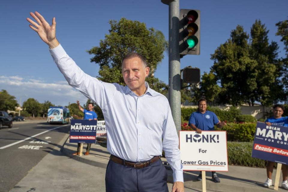 A man waves.