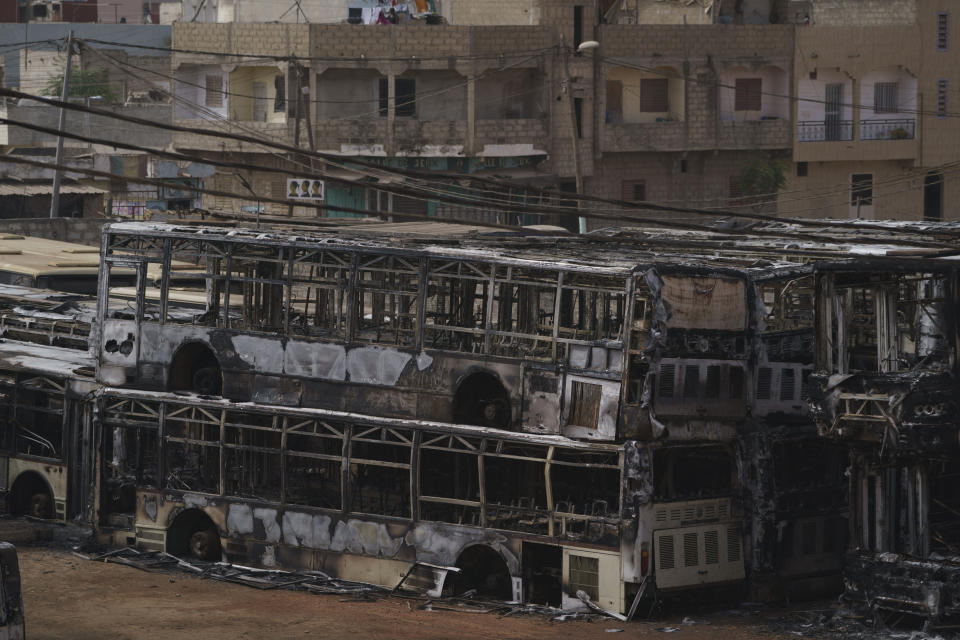 Burned buses are seen parked in a lot for out of service vehicles, after being set on fire, during protests, last night in Keur Massar, Dakar region, Senegal, Tuesday, May 16, 2023. According to the authorities at least three people died, including a police officer who was hit by a police vehicle, in Dakar and Ziguinchor during clashes between security forces and supporters of Senegalese opposition leader Ousmane Sonko. (AP Photo/Leo Correa)