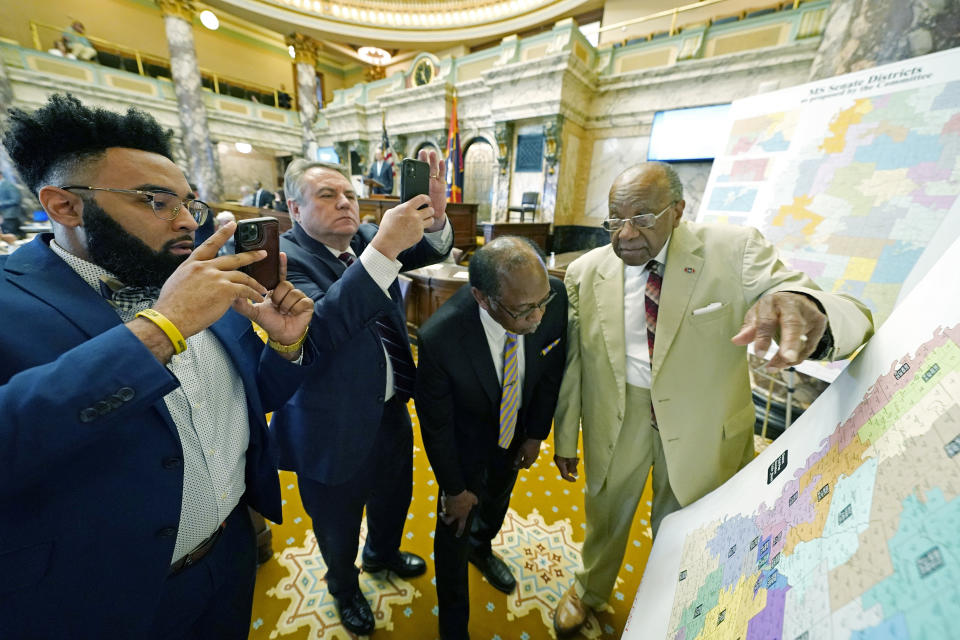 FILE - Mississippi state Sens. Rod Hickman, D-Macon, left, Michael McLendon, R-Hernando, second from left, Albert Butler, D-Port Gibson, and David Jordan, D-Greenwood, review an alternate Senate redistricting map during debate on the floor of the Senate at the Mississippi state Capitol in Jackson, Miss., March 29, 2022. The Mississippi NAACP filed a lawsuit Tuesday, Dec. 20, challenging the state House and Senate redistricting plans adopted by lawmakers in 2022 for use beginning in 2023 elections. The suit states that the plans dilute Black voting strength. (AP Photo/Rogelio V. Solis, File)