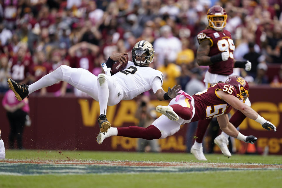 New Orleans Saints quarterback Jameis Winston (2) is flipped over by Washington Football Team linebacker Cole Holcomb (55) in the second half of an NFL football game, Sunday, Oct. 10, 2021, in Landover, Md. (AP Photo/Alex Brandon)