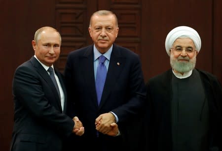 Presidents Putin of Russia, Erdogan of Turkey and Rouhani of Iran pose following a joint news conference in Ankara