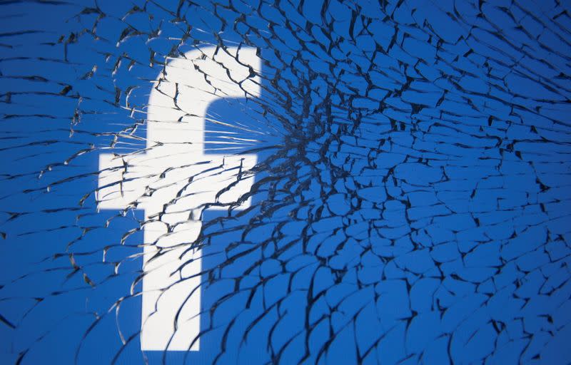 FILE PHOTO: Facebook logo is displayed through broken glass in this illustration