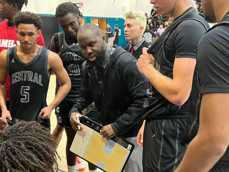 Palm Beach Central coach John St. Juste, a former Wellington assistant, discusses strategy with his team Thursday night.