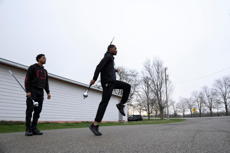 Joni Bargaineer, left, works through drum major routines with Jordan Harris Tuesday during a Wilberforce Hounds of Sound marching band practice.