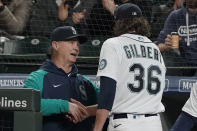 Seattle Mariners starting pitcher Logan Gilbert shakes hands with manager Scott Servais, left, after Gilbert pitched the seventh inning of a baseball game against the Houston Astros, Saturday, May 28, 2022, in Seattle. (AP Photo/Ted S. Warren)