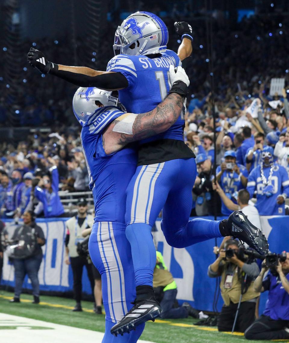 Detroit Lions wide receiver Amon-Ra St. Brown and left tackle Taylor Decker celebrate Brown's touchdown during the fourth quarter of the NFC divisional round playoff game at Ford Field in Detroit on Sunday, Jan. 21, 2024.