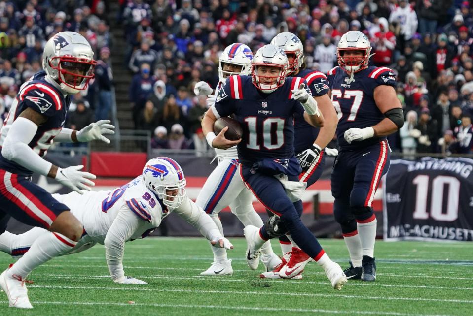 Patriots quarterback Mac Jones carries the ball against the Buffalo Bills on Dec. 26 at Gillette Stadium.