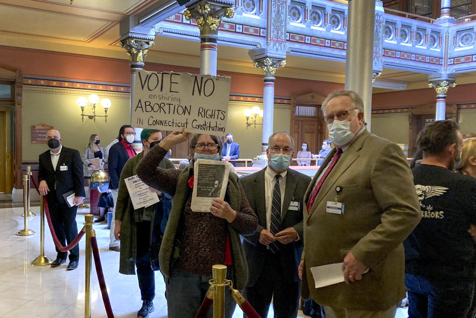 A protester demonstrates at the Connecticut State Capitol, Tuesday, April 19, 2022 in Hartford. As new abortion restrictions are imposed in some parts of the U.S., states with more liberal leadership have been passing laws to let a wider range of medical providers to do the procedures. (AP Photo/Sue Haigh)