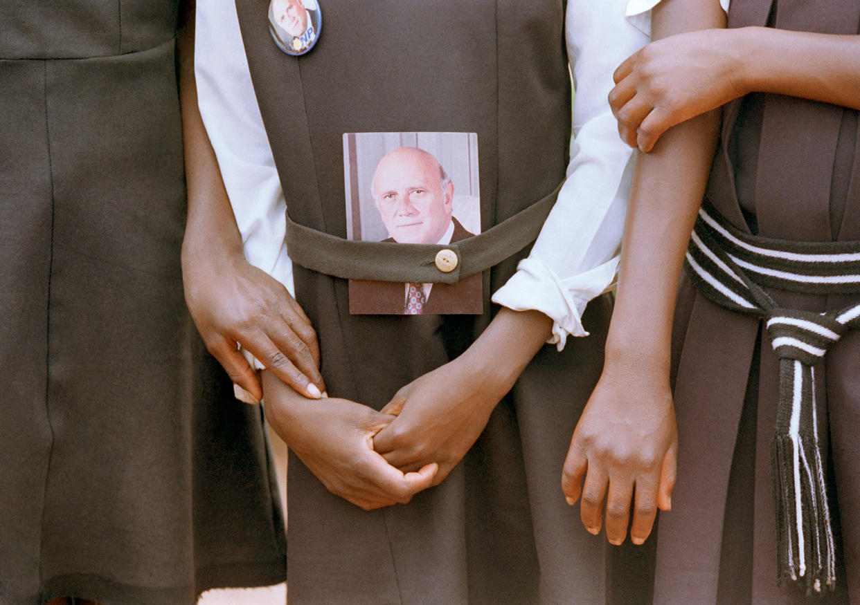 School children hold hands while awaiting the arrival of President F.W. de Klerk at a campaign rally in January 1994.