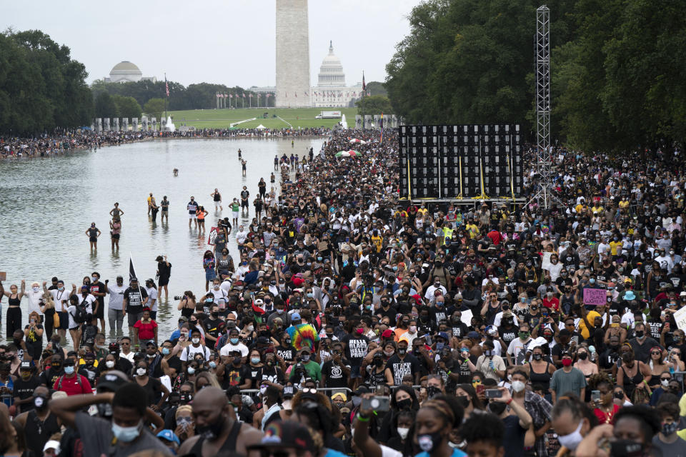 People gather at Lincoln Memorial to attend the March on Washington, Friday Aug. 28, 2020, on the 57th anniversary of the Rev. Martin Luther King Jr.'s "I Have A Dream" speech. (AP Photo/Jose Luis Magana)