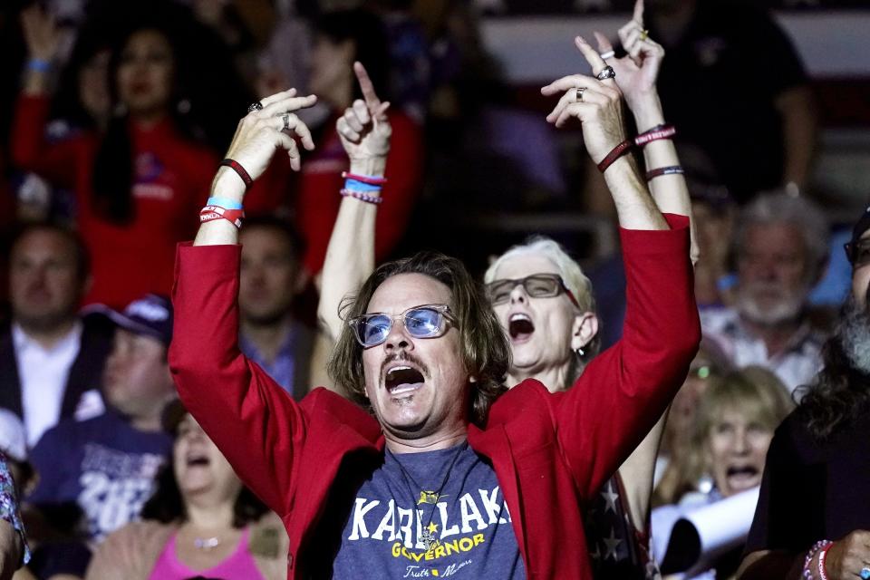 FILE - Supporters of former President Donald Trump cheer on Kari Lake, who is running for the Republican nomination for Arizona governor, during her speech at a Save America rally on July 22, 2022, in Prescott, Ariz. Lake, a well-known former television anchor, has delighted the segments of the GOP base that have long been at odds with their party’s establishment and want their leaders to confront Democrats, not compromise with them. (AP Photo/Ross D. Franklin, File)