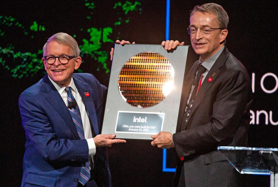 Ohio Governor Mike DeWine receives a plaque as a gift from Intel President and CEO Pat Gelsinger during an announcement that Intel will be investing 20 billion dollars building two computer chip factories in Jersey Township, in Licking County, during a live televised a presentation at the Midland Theatre in Newark, Ohio on January 21, 2022.