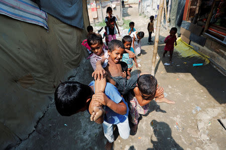 Children from the Rohingya community play outside their shacks in a camp in New Delhi, India October 4, 2018. REUTERS/Adnan Abidi