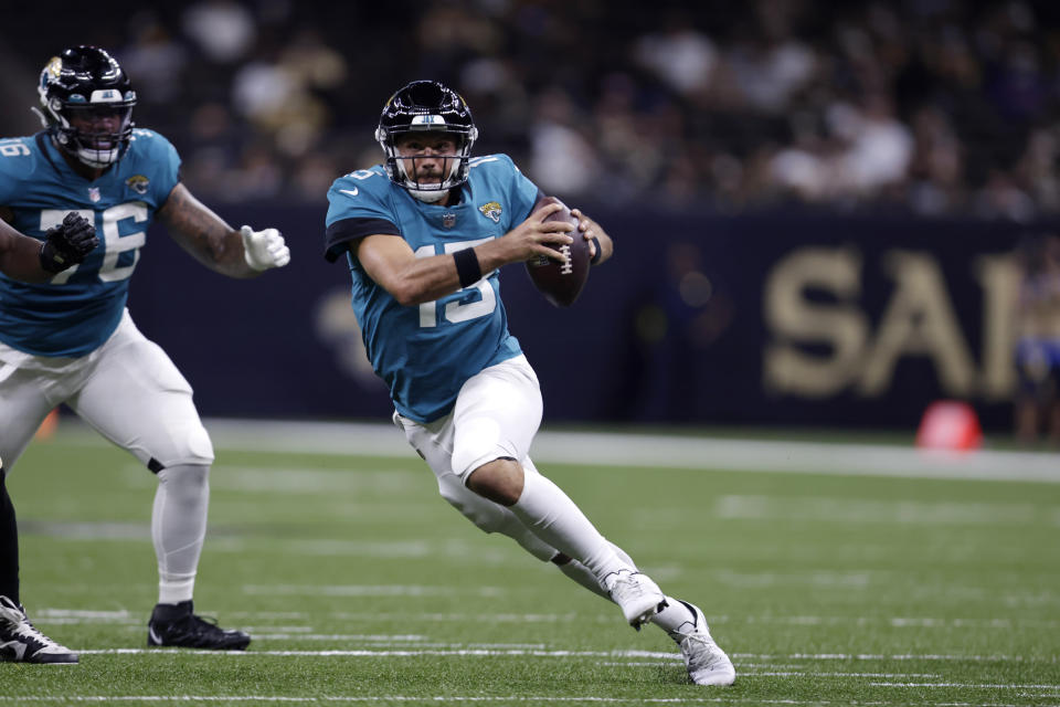 Jacksonville Jaguars quarterback Gardner Minshew (15) scrambles in the second half of an NFL preseason football game against the New Orleans Saints in New Orleans, Monday, Aug. 23, 2021. (AP Photo/Brett Duke)