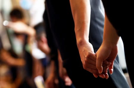 Protesters hold hands to form a human chain during a rally to call for political reforms in Hong Kong's Central district