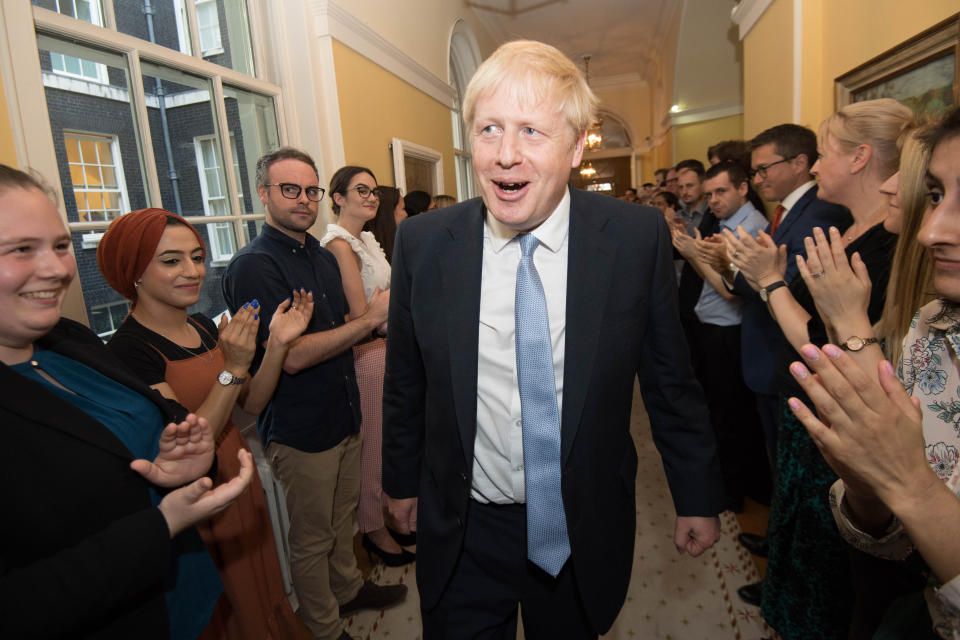 Prime Minister Boris Johnson is clapped into 10 Downing Street by staff after seeing Queen Elizabeth II and accepting her invitation to become Prime Minister and form a new government.