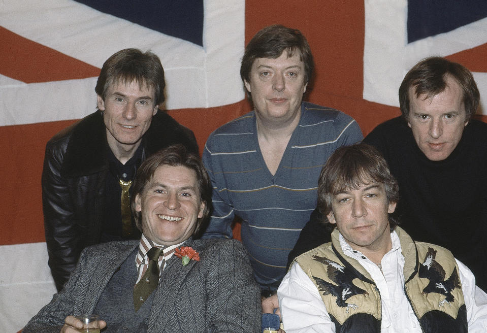 FILE - In this April 7, 1983 file photo, British pop group The Animals, from left, Hilton Valentine, Chas Chandler, John Steel, front row, Alan Price, and Eric Burdon, pose for photographers after announcing plans for a world tour, in London, England. Hilton Valentine, the founding guitarist of English rock and roll band The Animals who is credited with coming up with one of the most famous opening riffs of the 1960s, has died. He was 77. The band’s label ABKCO Music confirmed that Valentine died on Friday, Jan. 29, 2021 saying it was informed of the death by his wife Germaine Valentine. (AP Photo, File)