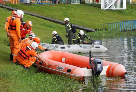 Police officers and rescue personnel prepare boats on the shore of the Penol-Guatape reservoir as the search for people believed to be missing continues after a tourist boat sank on Sunday, in Guatape, Colombia June 26, 2017. REUTERS/Fredy Builes