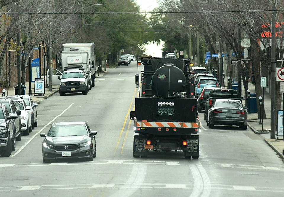 Trucks from the Public Service Department  put down a salt brine mixture along Front Street in Wilmington, N.C. Thursday Jan. 20, 2022 as steps are being taken to help keep the roads safer once the winter mix of rain, sleet and snow reaches the area.  [KEN BLEVINS/STARNEWS]