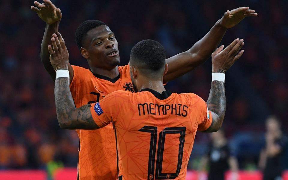 Denzel Dumfries celebrates with Memphis Depay after scoring the Netherlands' second goal - AFP