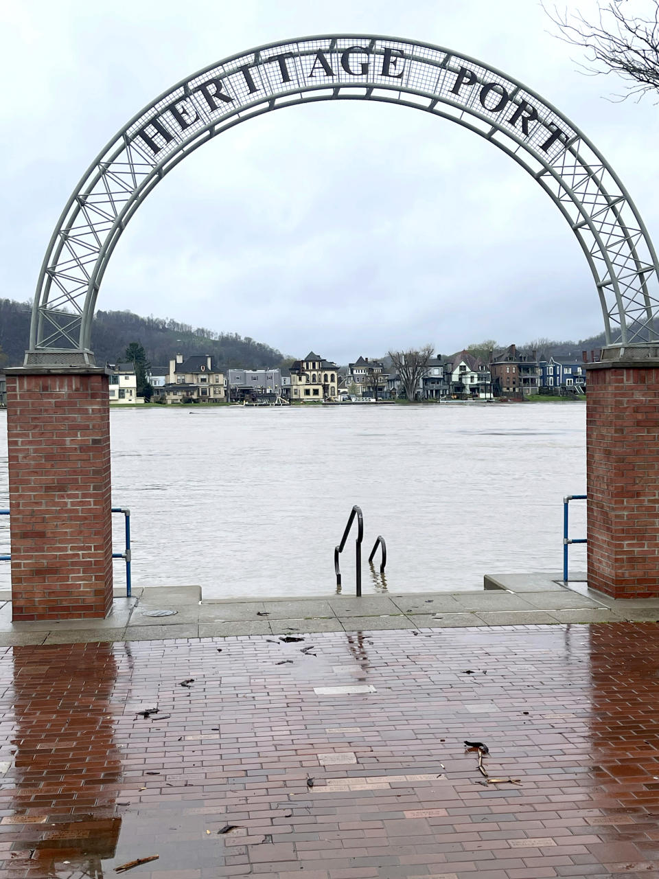 The Ohio River slowly creeps into the downtown business district at the city's Heritage Port, Thursday, April 4, 2024, in Wheeling, W.Va., following days of heavy rains in the region. (John McCabe/The Intelligencer via AP)
