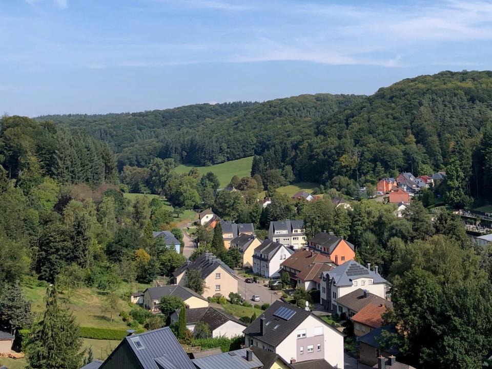 LaRochette, Luxembourg landscape with bright green trees and blue sky