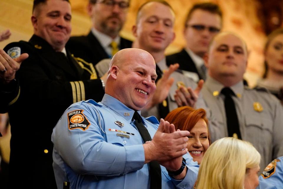 State trooper Jerry A. Parrish reacts as Gov. Brian Kemp speaks about him during the State of the State speech, Thursday, Jan. 11, 2024, in Atlanta. (AP Photo/Brynn Anderson)