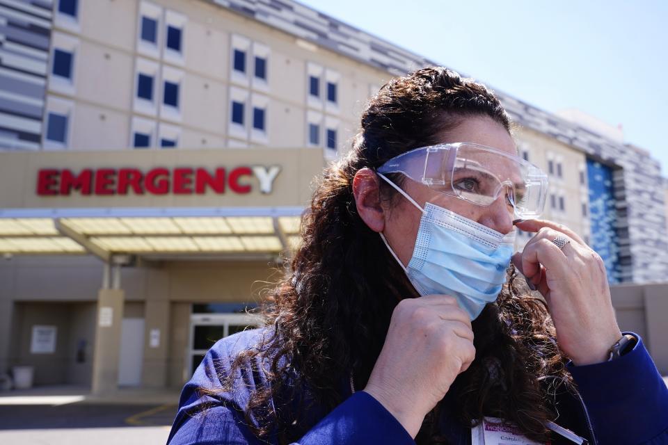 Caroline Maloney, a 55-year-old ICU nurse at Scottsdale Osborne Medical Center, has been treating COVID-19 patients throughout the entire pandemic, is shown Thursday, Aug. 26, 2021, in Scottsdale, Ariz. Arizona surpassed the grim milestone of 1 million confirmed coronavirus cases on Friday, Aug. 27, after the state reported new infections amid continued wrangling over vaccinations and mask requirements. (AP Photo/Ross D. Franklin)