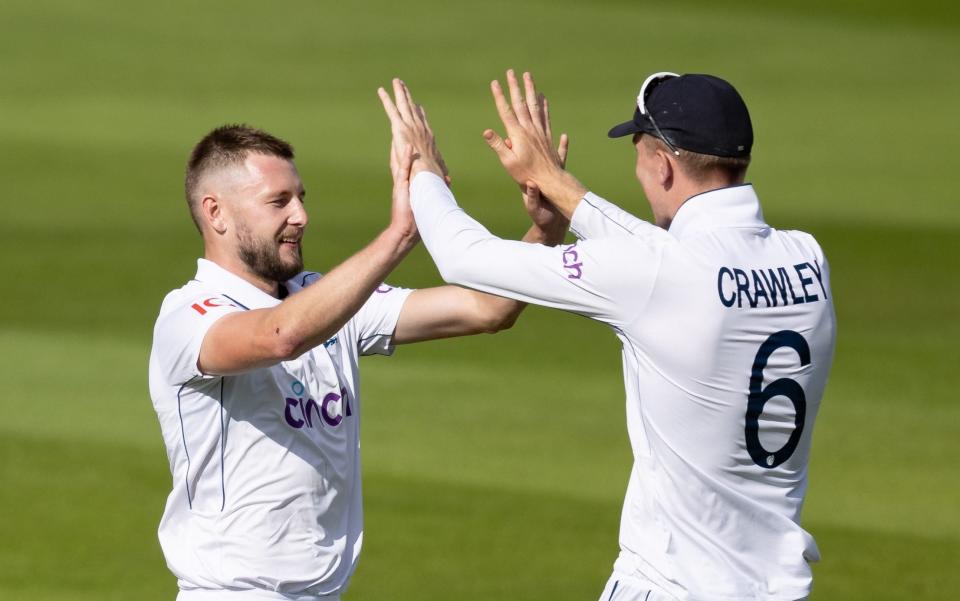 Gus Atkinson of England (left) celebrates with team mate Zak Crawley after taking the wicket of Jason Holder of West Indies during day one of the 3rd Rothesay Test Match between England and West Indies at Edgbaston on July 26, 2024 in Birmingham, England.