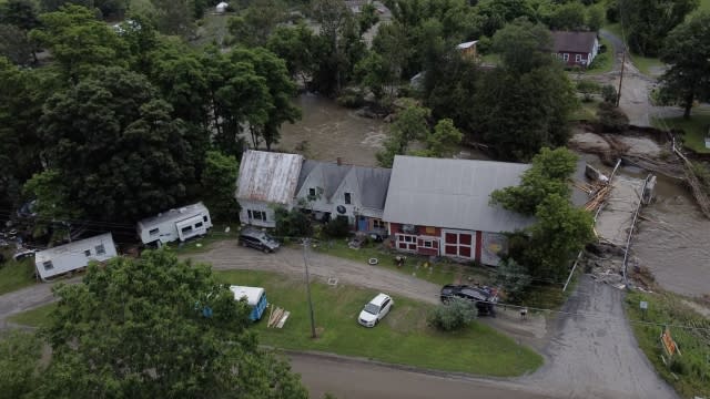 Floodwaters rush through a Vermont neighborhood.