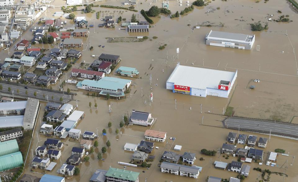 Houses are submerged in muddy waters in Sukagawa, Fukushima prefecture, as Typhoon Hagibis hits the area, northern Japan, Sunday, Oct. 13, 2019. Rescue efforts for people stranded in flooded areas are in full force after a powerful typhoon dashed heavy rainfall and winds through a widespread area of Japan, including Tokyo.(Takuya Inaba/Kyodo News via AP)