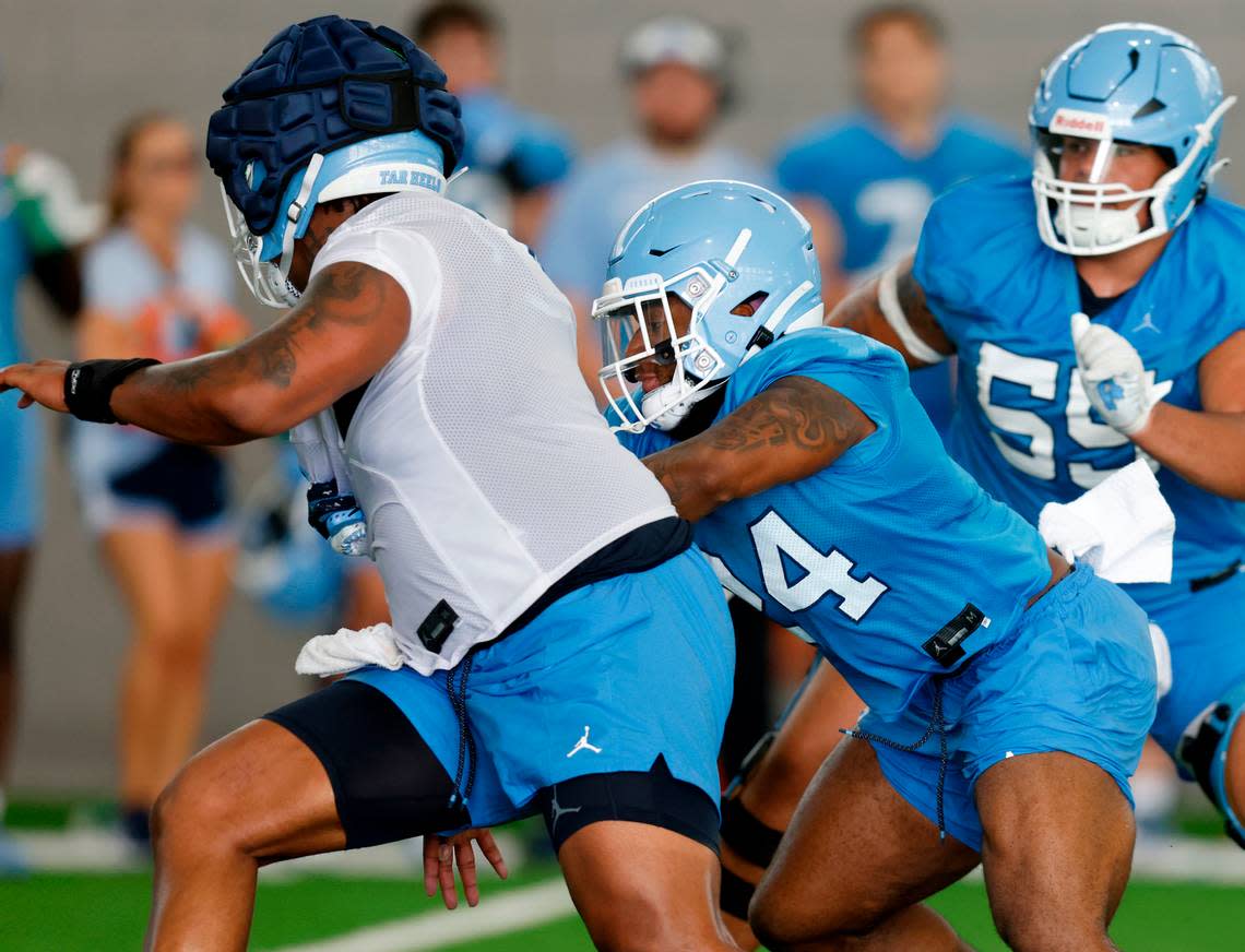 North Carolina running back British Brooks, center, runs a drill during UNC’s first football practice of the season on Friday, July 29, 2022, in Chapel Hill, N.C.