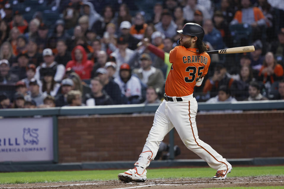 San Francisco Giants Brandon Crawford follows through on a two-run home run against Colorado Rockies during the sixth inning of a baseball game in San Francisco, Friday, July 7, 2023. (AP Photo/Josie Lepe)