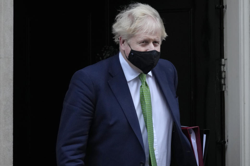 Britain's Prime Minister Boris Johnson leaves 10 Downing Street to attend the weekly session of Prime Ministers Questions in Parliament in London, Wednesday, Jan. 19, 2022. (AP Photo/Kirsty Wigglesworth)