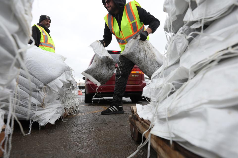 San Francisco Department of Public Works workers load sandbags into a car on January 03, 2023 in San Francisco, California. San Franciscans are preparing for a huge wind and rain storm that is expected to hit the San Francisco Bay Area on Wednesday.