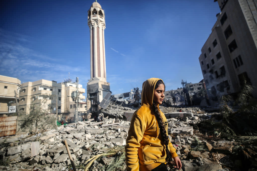  Palestinians are inspecting the debris at the Jaffa Mosque, which was hit by an Israeli bombardment, in Deir el-Balah, in the central Gaza Strip. 