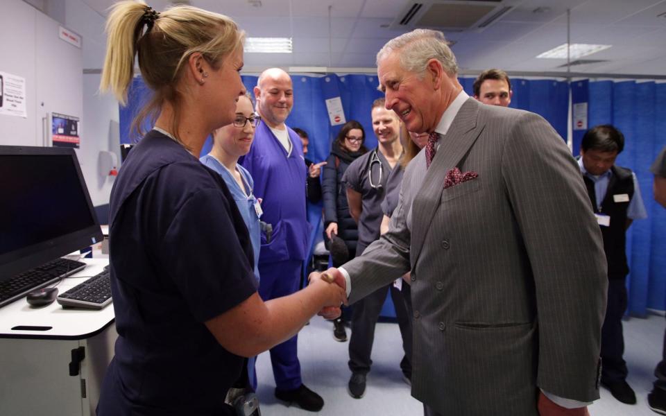 Prince Charles shakes a medic's hand in hospital - Credit: Yui Mok/PA