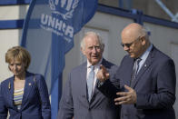 Britain's Prince Charles, center, listens to the head of Romania's Department for Emergency Situations (DSU) Raed Arafat, right, during a visit at a center for refugees fleeing the war in neighboring Ukraine, at the Romexpo convention center, in Bucharest, Romania, Wednesday, May 25, 2022.(AP Photo/Vadim Ghirda)