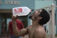 <p>Julio Ortiz Montanez drinks water at the Jose Robles Otero Elementary School after the passing of Hurricane Maria, in Toa Baja, Puerto Rico, Friday, Sept. 22, 2017. Because of the heavy rains brought by Maria, thousands of people were evacuated from Toa Baja after the municipal government opened the gates of the Rio La Plata Dam. (Photo: Carlos Giusti/AP) </p>