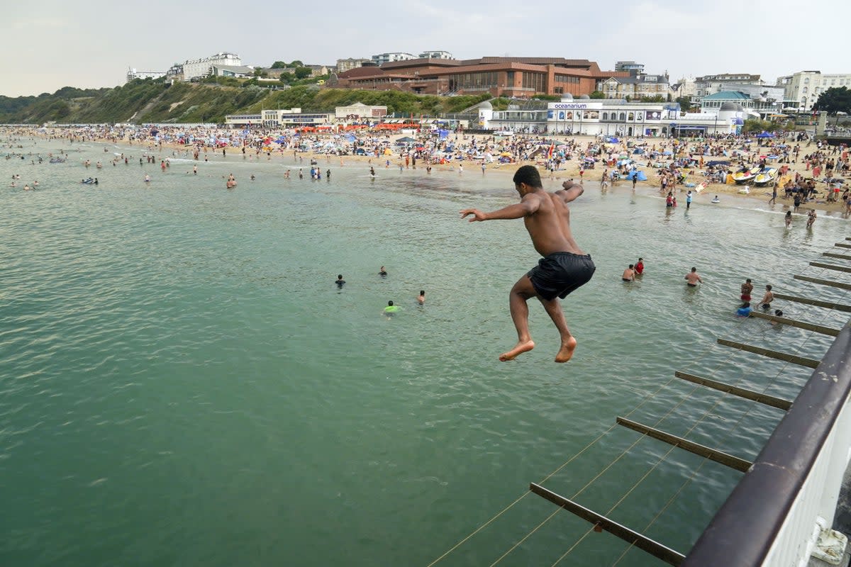 A man jumps from the pier in Bournemouth (PA) (PA Wire)