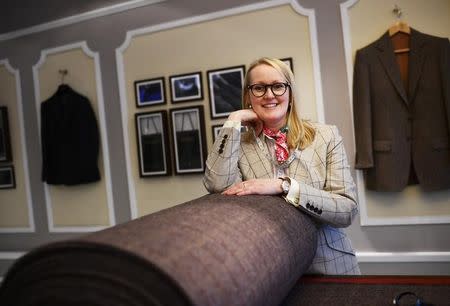 Master Tailor Kathryn Sargent poses with a roll of her own fabric 'Sargent Harris Tweed' inside her Bespoke Tailoring shop at Saville Row in central London, Britain, April 6, 2016 . REUTERS/Dylan Martinez