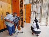 Members of the media film the defaced statue of Confederate commander General Robert E. Lee, at Duke University's Duke Chapel in Durham, North Carolina, U.S. August 17, 2017. REUTERS/Jonathan Drake