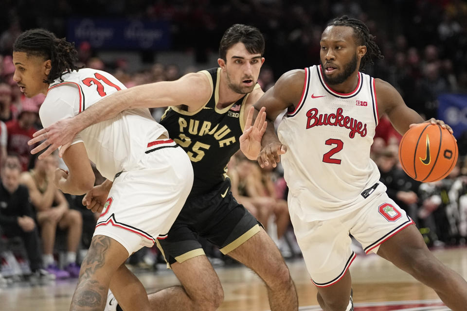 Ohio State guard Bruce Thornton (2) drives past Purdue guard Ethan Morton (25) in the second half of an NCAA college basketball game, Sunday, Feb. 18, 2024, in Columbus, Ohio. (AP Photo/Sue Ogrocki)